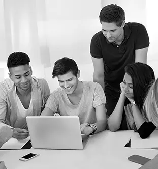 Students gathered around a laptop